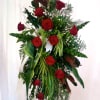 Tall standing arrangement of red roses and mixed greenery