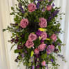 Tall standing floral spray with pink roses and purple blooms