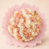 Round bouquet of blush and ivory roses wrapped in pink paper