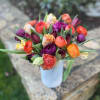 Gorgeous local ranunculus and tulips in shades of orange, coral, plum and