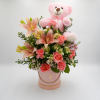 Soft peach-pink lilies and coral roses take center stage in this pink-and-white