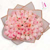 Large bouquet of pale pink roses wrapped in translucent paper