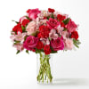 Pink and red mixed bouquet in a clear glass vase