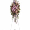 Tall pink and purple floral spray on a white easel