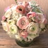 Make an impact with this feminine arrangement in light and pretty colors.