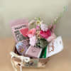 A wellness basket in the pretty colors of pink, white and green