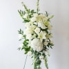 Tall white floral standing spray with roses, lilies, and hydrangeas