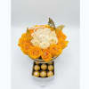 Yellow and white rose arrangement in a round box with chocolates below