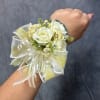 White rose wrist corsage with a sheer ribbon bow