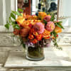 Orange and pink mixed bouquet in a glass vase