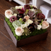 Succulent and rose arrangement in a wooden box