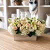 Cream and blush flower arrangement in a wooden box