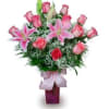 Pink roses and lilies arranged in a purple vase