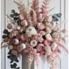 Large pink and white floral arrangement with tulips and roses