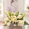 Cream floral arrangement in a textured rectangular container