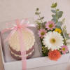 Gift box with a cupcake and a small flower arrangement