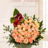 Peach and blush roses form a lush, rounded mound that reads like