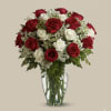 Red and white roses arranged in a clear glass vase
