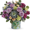 Compact bouquet of purple and green flowers with a succulent in a mosaic cylinder vase