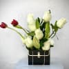 White and red tulips arranged in a black handbag-shaped box