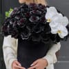 Black rose bouquet with white orchids in a black wrap