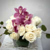 White roses with pink orchids in a square glass vase