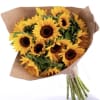 Bouquet of yellow sunflowers wrapped in brown paper