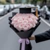 Pink rose bouquet with a graduation cap topper and ribbon