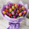 A vibrant mix of purple, yellow, red, and pink tulips beautifully arranged