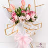 Pink tulips and roses in white wrap with a pink ribbon