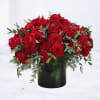 Low arrangement of red roses in a black cylinder vase