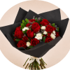 A dense cluster of velvety red roses framed by crisp white blooms