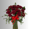 Bouquet of red roses in a glass vase with a red ribbon