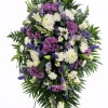 Large standing floral spray with white, purple, and lavender flowers