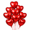 Cluster of red heart-shaped balloons on white background