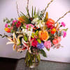 Order this beautiful spring arrangement with roses, tulips, orchids, stock, lilies, and