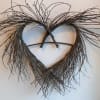 Heart-shaped twig wall hanging with wispy branches at the top
