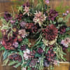Large floral wreath with burgundy and blush blooms on a wooden door