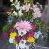 Mixed flower arrangement in a white mug labeled Dog Mom