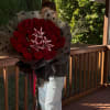 Large bouquet of red roses with white lilies wrapped in black polka-dot paper
