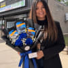Woman holding a bouquet of blue roses and Hot Wheels packages