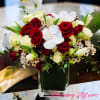 Red and white spray roses, white orchids and tulips.