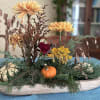 A 15" shallow wooden bowl with two smaller bowls holding coordinating ikebana