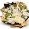 Soft cream roses and bright green hydrangeas form the first impression of