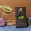 Chocolate bar box beside a white anthurium and purple chrysanthemum