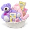 Baby gift basket with plush toys, blankets, and care items