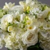 White floral bouquet with roses, hydrangeas, and freesia