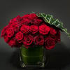 Low and dense floral arrangement of red roses