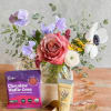 Bouquet in a glass vase with a chocolate bar and hand cream