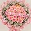 Pink rose bouquet with baby's breath, a crown topper, and a ribbon banner